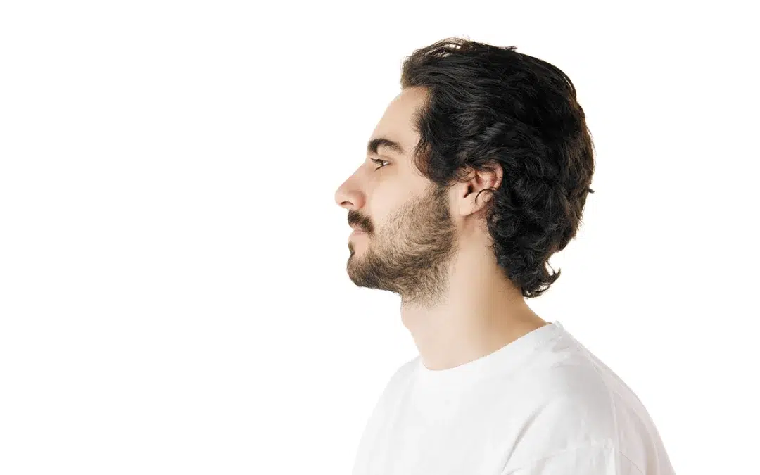 side view portrait of young attractive man with dark thick curly hair and beard