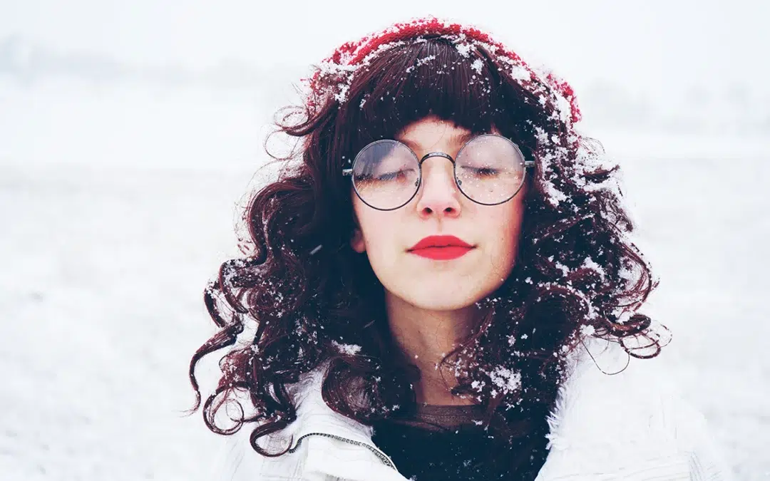 young and pretty woman enjoying a snowy winter day